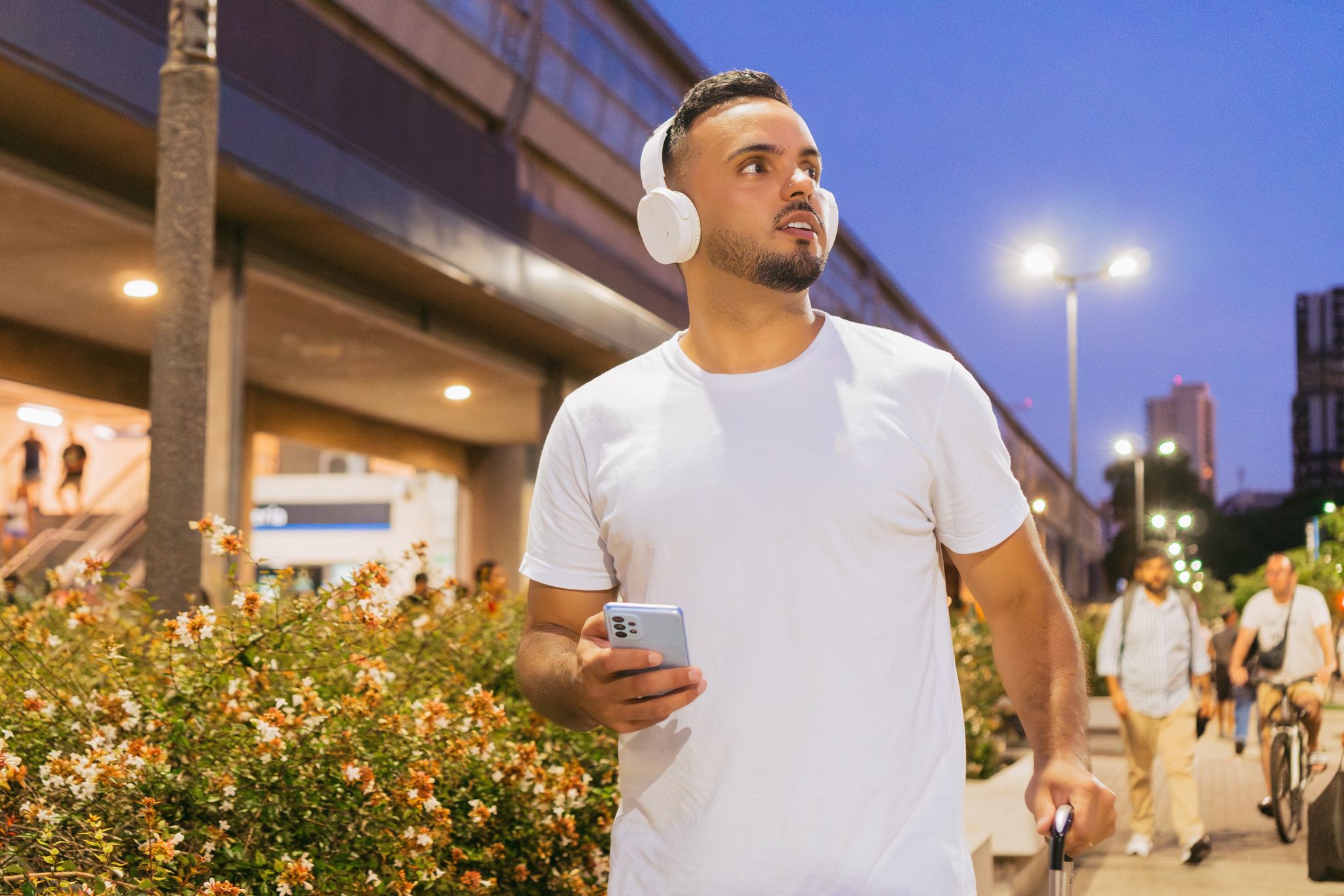 Person with smartphone and headphones enjoying mountain drive audio tour
